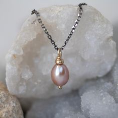 A beautiful  pink pearl hand-crafted 9ct gold setting or silver thread and displayed on a Sterling Silver chain.  Choose Oxidixed, Classic Silver or 9ct Yellow Gold. Pink pearl; feminine and eye-catching. A timeless and classic jewellery set with unique artisan detailing. Beautiful enough for special occasions but also the perfect addition to your everyday wardrobe. PINK PEARL NECKLACE DETAILS LENGTH Pearl 12mm Chain 40cm THE CRAFTING JOURNEY Handcrafted in my Northumberland Studio, this simple Elegant Handmade Rose Gold Pearl Necklace, Teardrop High Luster Pearl Necklace For Gift, Teardrop High Luster Necklace As A Gift, Teardrop High Luster Necklace Gift, Briolette High Luster Pearl Necklace Gift, High Luster Briolette Pearl Necklace As Gift, High Luster Briolette Pearl Necklace For Gift, Rose Gold High Luster Jewelry For Gift, Oval Pearl Charm Jewelry Gift