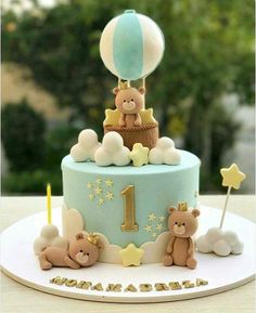 a baby's first birthday cake with teddy bears on top