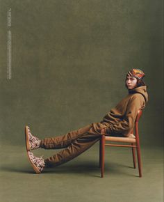 a man sitting on top of a wooden chair