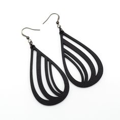 black leather tear shaped earrings on white background