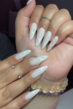 Opt for understated elegance with almond nails boasting a natural base color by @nails.bybriiiiiiii, adorned with abstract white lines for a clean and sophisticated manicure. Explore endless creativity with Nailustrous - For 25 Almond Nail Design Ideas and more, visit our website and elevate your nail game today! Sophisticated Manicure, Nail Games