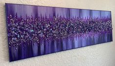 a purple painting hanging on the wall