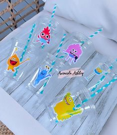 there are many cartoon stickers in the bottles on the bed side table, which is decorated with blue and white paper straws