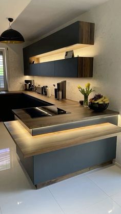 a modern kitchen with an island countertop and built - in lighting is seen here