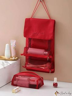 a red bag hanging from the side of a wall next to a white counter top