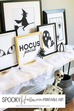 halloween printable art is displayed on a mantle with skeletons and pumpkins in the background