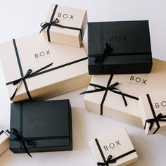 six boxes with black and white ribbons tied around them