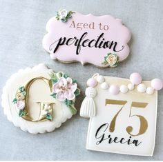 three decorated cookies with the words aged to perfection written on one cookie and the number seventy