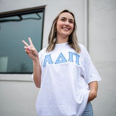 This trendy & unique Basic Minimalistic Sorority Comfort Colors Crew Neck Greek Letter Shirt is sure to stand out on any campus! Grab one for you, your big/little, or a group of sisters Picture Details ⭑ #1-2: White Shirt, Light Blue top fabric, Royal Blue thread color ⭑ #3: White Shirt, Light Purple top fabric, Purple thread color Care Instructions ⭑ Wash inside out on cold & air dry for best results ⭑ Do not dry clean ⭑ Light iron if necessary ⭑ Care instructions are included with every order. Preppy Cotton T-shirt With Letter Print, Spring Cotton Varsity T-shirt, Spring Varsity Top For Campus, White School Spirit Top For Spring, Preppy White T-shirt For Spring, Spring College Style T-shirt, Varsity Cotton Tops For School, Varsity Tops For College In Spring, White Varsity Tops For School