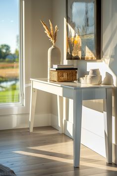 Sunlit corner in a modern farmhouse chic living room featuring a minimalist console table decorated with a vase, books, and woven baskets.