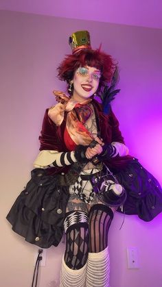 a woman dressed up as a clown with makeup and accessories on her face, posing for the camera