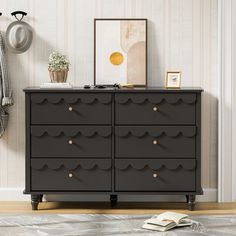 a black dresser sitting in front of a white wall