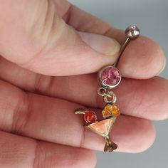 a person holding a tiny charm in their hand