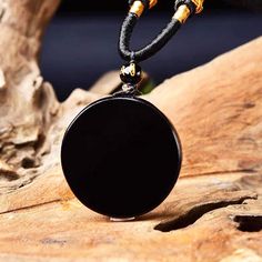 This stunning true black obsidian scrying mirror necklace helps you get in touch with your unconscious minds: the realm of the soul. A wonderful divination tool to get in touch with your core needs, dreams and goals. Black Obsidian Stone is a powerful cleanser of psychic smog created within your aura and is a strong psychic protection stone. This stone has powerful metaphysical properties that will help to shield you against negativity. The energy of these stones may stimulate the gift of prophe Black Obsidian Amulet Necklaces, Black Obsidian Amulet Necklace, Black Obsidian Necklace With 108 Beads, Black Pendant Crystal Necklaces For Meditation, Black Crystal Pendant Necklaces For Meditation, Black Pendant Crystal Necklace For Meditation, Black Obsidian Necklaces For Meditation, Black Amulet Jewelry For Meditation, Black Obsidian Necklace For Healing