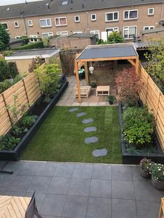 a small backyard with grass and stepping stones