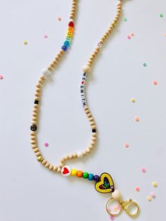 ✏️ Gift your teacher with a custom lanyard! ✏️ This custom lanyard is adorable, and always needed by teachers to wear their key/badge.  Adorned w/rainbow colors, boho & smiley face accents.  Has a break free clasp & is plenty long for any user.  Msg me for any additional beads to represent school colors!   Also included, ✏️ Personalized name, mascot, school or word of your choice, maximum 3" of text beads ✏️ Shipping is Free and will be in the mail in 1-2 days  Lanyard Dimensions  Lanyard total Cheap Personalized Beaded Lanyards, Cheap Multicolor Beaded Lanyards, Custom Teacher Appreciation Gifts, Custom Tissue Paper, Custom Lanyards, Tissue Paper Wrapping, Heart Rainbow, Teacher Appreciation Gift, Silk Cord