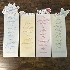 three bookmarks with different words on them sitting on a table next to each other