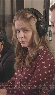 two women wearing headphones sitting at a table