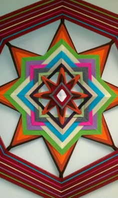 a multicolored star is hanging on the wall