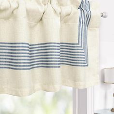 a curtain with blue and white stripes hanging from the side of a window sill