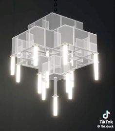 a chandelier with lights hanging from it's sides and cubes in the middle