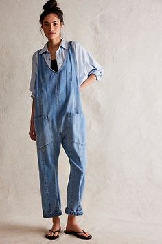 One-and-done and so simple, this denim jumpsuit from our We The Free Collection is featured in a relaxed fit and cropped ankle-length style with harem legs and a low scoop neckline. **Fit:** Slouchy, relaxed fit; ankle-length, pull-on style **Features:** Denim fabrication, rigid feel, low scoop neckline, seam detail throughout, oversized patch pockets, drop-crotch harem-style legs, low back with adjustable shoulder straps **Why We | We The Free High Roller Jumpsuit at Free People in Light Wash, Denim Jumpsuits, High Roller, Strapless Mini Dress, Denim Jumpsuit, Amelie, Dress With Bow, Low Back, Boho Outfits, Sweater Hoodie