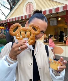 a man holding two pretzels in front of his face