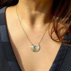 Stunning in refined simplicity. This necklace makes a statement on its own or in a layered look. 14K Gold Rainbow Moonstone Cab Pendant is 7/8"wide 18" Chain We use natural gemstones making each piece unique. The color and characteristics of each stone may vary slightly from image and piece to piece. Please allow 3-4 weeks for this item to be delivered. Modern Round Cabochon Necklace, Modern Cabochon Necklace, Oval Cabochon Brass Necklace, Gold Moonstone Jewelry With Gemstone Beads, Gold Moonstone Gemstone Necklace, Gold Gemstone Necklace With Moonstone, Gold Moonstone Necklace With Gemstone, Yellow Gold Moonstone Necklace With Round Pendant, Gold Oval Pendant Necklace In Labradorite