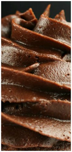 chocolate frosted cake sitting on top of a white plate