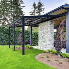 an outdoor covered patio with grass and trees in the background