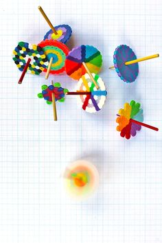 several colorful lollipops on a white sheet with some colored sticks sticking out of them