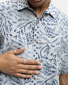 Short sleeve cotton shirt featuring a point collar, scalloped hem, coconut button closure, chest patch pocket, Indigo dye, block print. Due to the dyeing process, we recommend sizing up. MADE IN INDIA. DAOUDA IS 6'1 AND WEARING A MEDIUM. MR149-09GZ-131 Summer Block Print Shirt With Short Sleeves, Casual Block Print Short Sleeve Tops, Casual Short Sleeve Tops With Block Print, Casual Short Sleeve Block Print Tops, Summer Short Sleeve Shirt With Block Print, Cotton Indigo Shirt With Buttons, Summer Cotton Shirt With Batik Print, Casual Patterned Shirt With Block Print, Casual Patterned Block Print Shirt