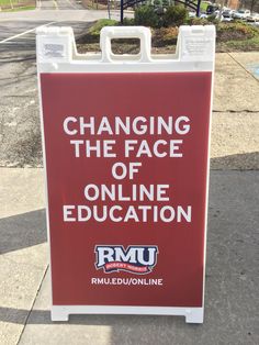 a red sign that says changing the face of online education on it's side