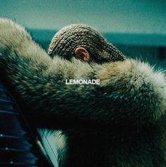 a person wearing a fur coat with the word lemonade written on it