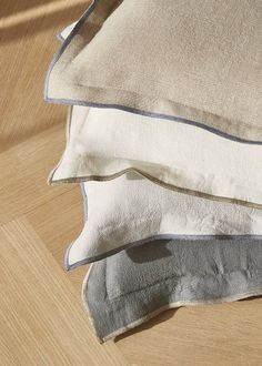 three pillows stacked on top of each other in front of a computer screen with the word zara home