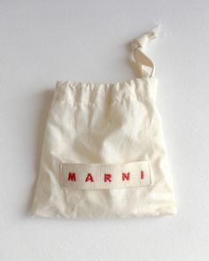 a white bag with the word marni written on it and a string attached to it