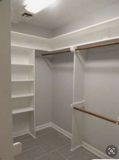 an empty walk in closet with white walls