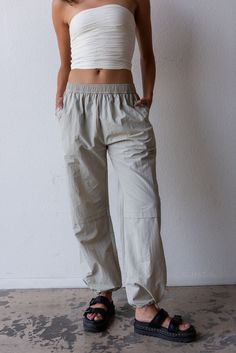 The cargo is back and so is low rise? That's right, this trend is sticking around and we are in obsessed! Color: Grey Mist Loose Fit Elastic Waist Pockets Drawstring Ankle Relaxed Leg Nylon Model is 5'9", size 24 in bottoms and is wearing medium Everyday Parachute Pants With Side Pockets For Spring, Relaxed Fit Linen Cargo Bottoms, Relaxed Fit Linen Cargo Style Bottoms, Beige Linen Cargo Bottoms, Casual Summer Cargo Jeans With Elastic Waistband, Casual Cargo Jeans With Elastic Waistband For Summer, Casual Linen Parachute Pants With Cargo Pockets, Summer Mid-rise Cargo Parachute Pants, Relaxed Mid-rise Bottoms With Pockets