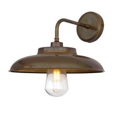 an antique brass wall light with a clear glass bulb on the front and back of it