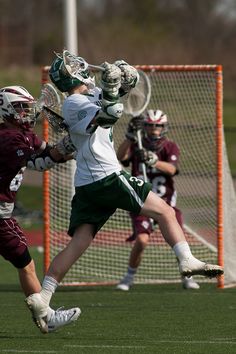 two men playing lacrosse on a field