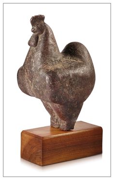 a sculpture of a chicken on a wooden base with a white background and brown frame