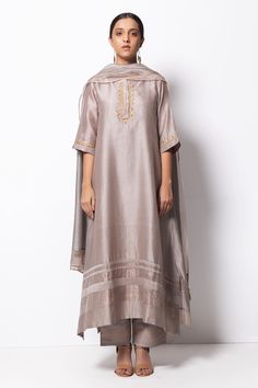 Silver grey kurta highlighted with zardozi embroidery, round neckline and straight silhouette. Comes with cotton silk pant, chanderi dupatta and inner slip.
Component: 4
Pattern: Embroidered
Type Of Work: Zardozi
Neckline: Round
Sleeve Type: Three Quarter
Fabric: Kurta: Handwoven Chanderi Silk; Dupatta: Chanderi; Pant: Cotton Silk
Color: Grey
Other Details: 
Straight kurta
Concealed placket
Side pockets
Asymmetric hem
Contrast hem pant
Dupatta with tassels
Occasion: Mehendi and Haldi, Puja - Aza Chanderi Suits Design, Grey Kurta, Silk Kurta Set, Chanderi Dupatta, Zardozi Embroidery, Indian Designer Suits, A Line Kurta, Silk Kurta, Suits Design