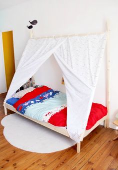 a child's bed with a white canopy over it