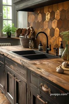 a kitchen with wooden counter tops and black cabinets in the background is a window that has honeycombs on it