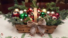 a basket filled with christmas ornaments on top of a table