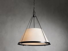 a light fixture with a white shade hanging from it's center point on a gray wall