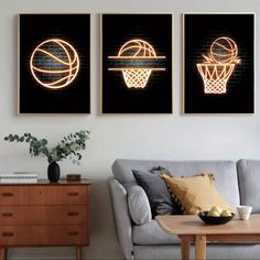 three canvases with basketballs on them in a living room