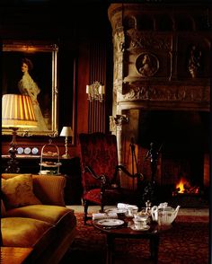 a living room filled with furniture and a fire place in front of a painting on the wall