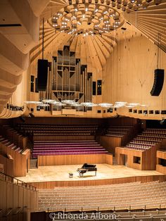 the interior of a concert hall with an organ and piano on the far side,