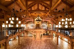 the inside of a building with wooden floors and chandeliers